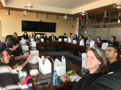 Grad Students sitting around a hollow-square conference table