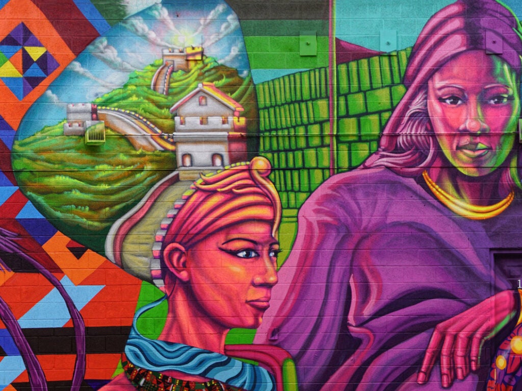 Mural in many colors of two women in an artistic rendering