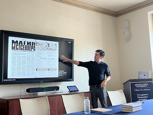 Dr. Gorski at a display with Russian material on screen 
